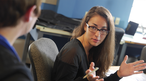 A female student at La Roche University collaborates with a classmate in a core curriculum. 